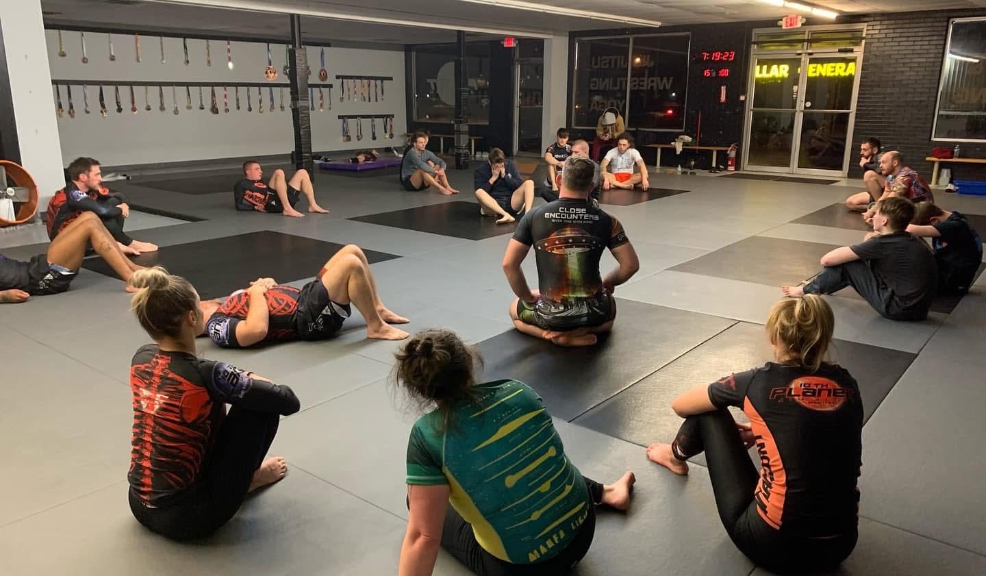 An instructor teaching a seated adults class in the evening