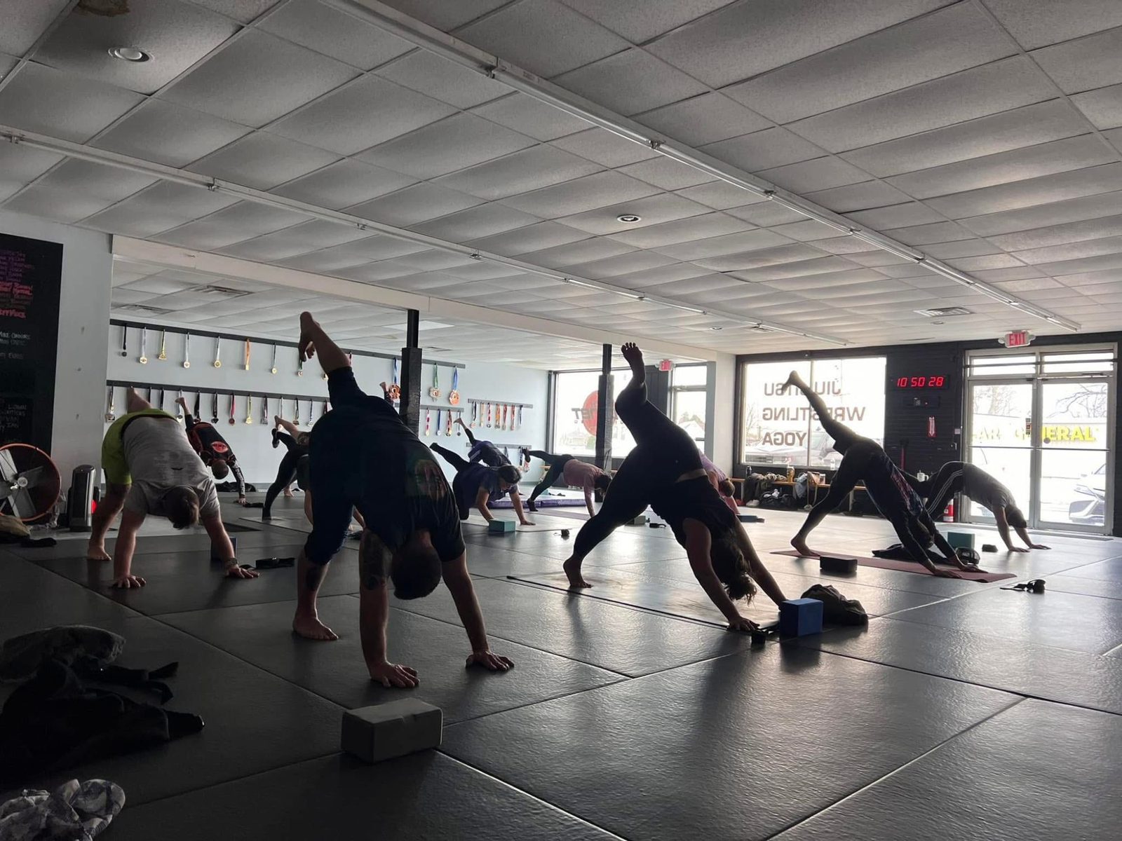 A yoga class on the mats at 10th Planet